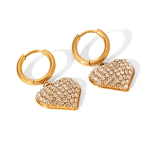 Detail of golden stainless steel hoop earrings with heart-shaped crystal pendants