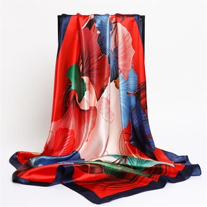 Detailed close-up showing silky satin fabric texture and colorful ginkgo leaf print