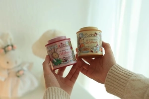 Detailed close-up of bunny and hedgehog themed mini tin boxes with vintage animal illustrations