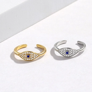 Detailed view of adjustable evil eye rings with blue crystals in gold and silver finishes