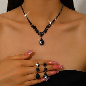 Detailed view of bridal jewelry set with black teardrop rhinestones on a model