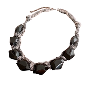 Layered silver-tone chain necklace featuring a large black acrylic faceted pendant