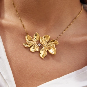 Elegant gold stainless steel necklace with dual flower petals and small zircon accent