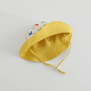 Detail of kids sun hat showing colorful graffiti pattern and yellow stitched brim with chin strap