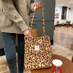 Detailed close-up of leopard print corduroy tote bag with decorative stitched label