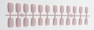 Macro view of 24 pieces nude matte square long press-on nails on a plastic runner