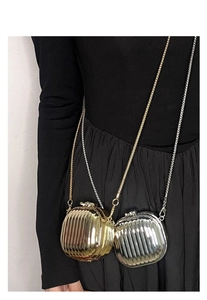 Close-up of mini metallic crossbody bags with ripple texture in gold and silver finish