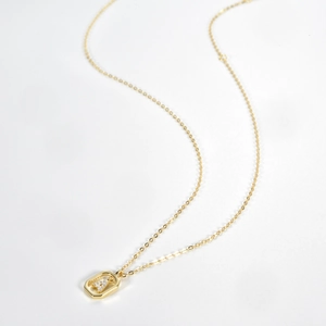 Detail showing S925 hallmark on gold plated sterling silver necklace with letter A