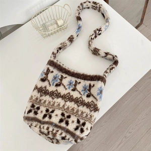 Detail of plush bucket bag featuring soft cream fleece and geometric knit patterns