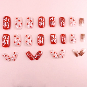 Christmas press-on nails set with red hearts, candy canes and festive HO HO HO patterns