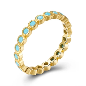 Detailed close-up of 18k gold plated eternity ring set with round green turquoise stones