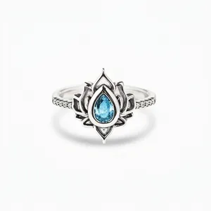 Vintage silver lotus ring featuring a pear-cut blue gemstone and intricate pave diamond accents