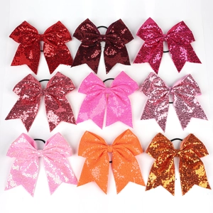 Détail de neuf élastiques à cheveux à nœuds en paillettes colorées pour filles