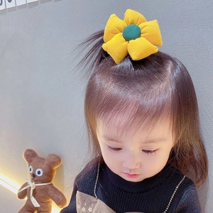 Yellow fabric flower hair elastic for girls featuring a cute floral design and soft material