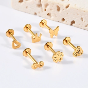 Detailed set of golden stainless steel flat back piercings with crown and butterfly designs