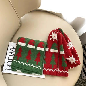 Kids knitted Christmas scarves in red and green with festive tree and snowflake patterns