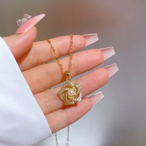 Macro detail of gold rotating flower necklace with micro-paved zircons and center pearl