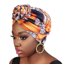 Detail of orange and navy ethnic pattern headscarf showing elastic fabric texture