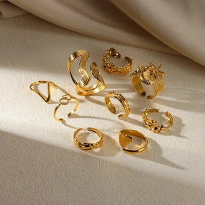 Detailed set of 9 gold rings featuring sea stars shells and fluid lava wave textures