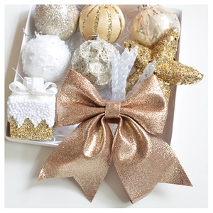 Festive gold and white Christmas ornament set with sequins and bows in a white gift box