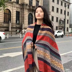 Ethnic style colorful geometric striped knit scarf for women in an outdoor urban setting