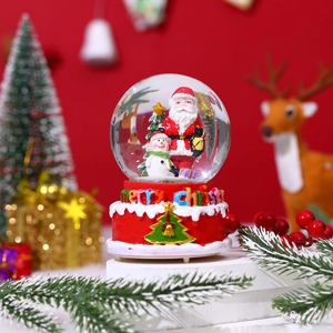 Musical Christmas snow globe with Santa and snowman on a festive red base