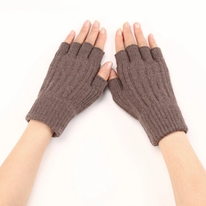 Detail of brown cable-knit fingerless gloves showing the warm texture and wrist coverage