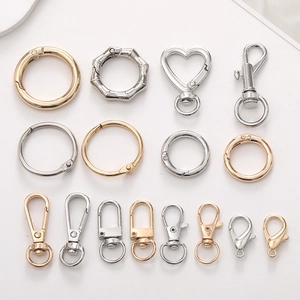 Assorted zinc alloy spring rings, lobster clasps, and metal gate rings in gold and silver