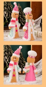 Detail of gingerbread dolls with sequined hats and knit outfits for Christmas decor