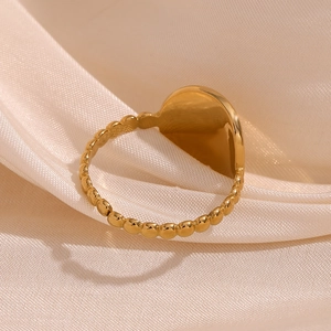 Detail of 18K gold-plated starburst ring with beaded band on elegant silk fabric