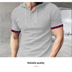 Detail of light gray waffle fabric polo shirt with plaid trim on the cuffs and hood
