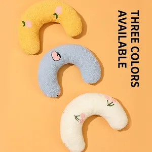 U-shaped plush cat neck pillow in yellow, blue, and white with soft fleece texture