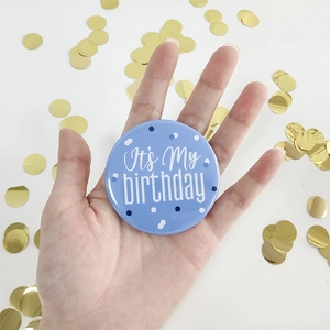 Sky blue Happy Birthday tinplate badge held in hand with gold sequins decoration
