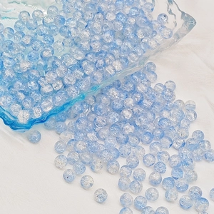 Detailed view of blue cracked glass beads for DIY jewelry and handmade crafts