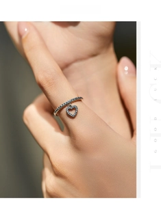 Detail shot of a s925 silver ring featuring a sparkling pavé heart charm and micro-inlay