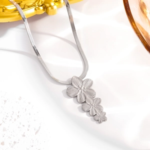 Elegant silver three-layered flower pendant necklace with fine snake chain on white background