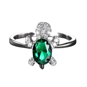 Elegant silver turtle ring featuring a large green gemstone and white pave-set stones