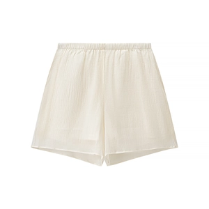 Detailed flat lay of light beige textured shorts with an elasticated waistband detail