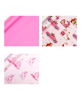 Detailed view of three pink gift wrapping paper designs featuring cartoon holiday motifs