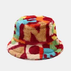 Detail of colorful plush bucket hat featuring multi-color faux fur patchwork and texture