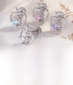 Detailed view of apple-shaped silver ear stud with rabbit design and heart zircon