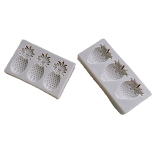 Rectangular light gray silicone molds featuring realistic pineapple and strawberry cavities