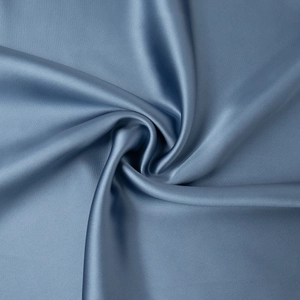 Close-up of elegant blue satin fabric with silky texture and metallic luster detail