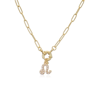 Detailed close-up of a gold necklace with a Leo zodiac pearl pendant on a paperclip chain