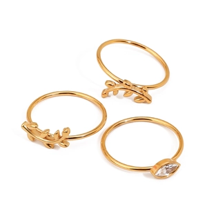 Close-up of three-piece gold leaf rings set with marquise-cut crystal in detail