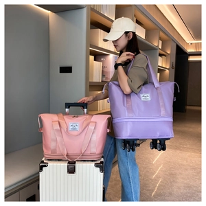 Detail of pink and purple travel bags with universal wheels and expandable zippers