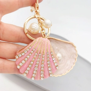 Pink enamel shell keychain with rhinestones and white pearls on gold metal ring