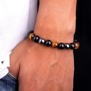 Men's beaded bracelet with natural tiger eye, obsidian, and hematite stones on wrist