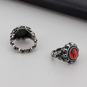 Macro shot of punk skull engraving on titanium steel ring with red dragon eye gemstone
