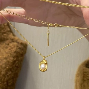Golden bean necklace with irregular pearl pendant on twisted chain for women